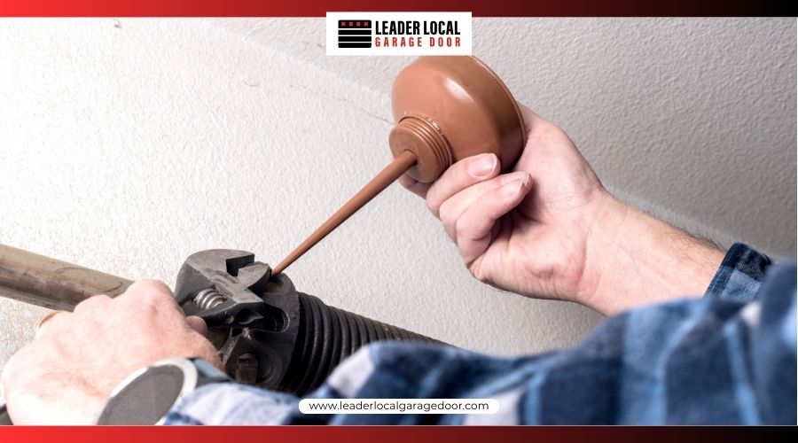 A snapped steel torsion spring with a visible gap on a garage door header.