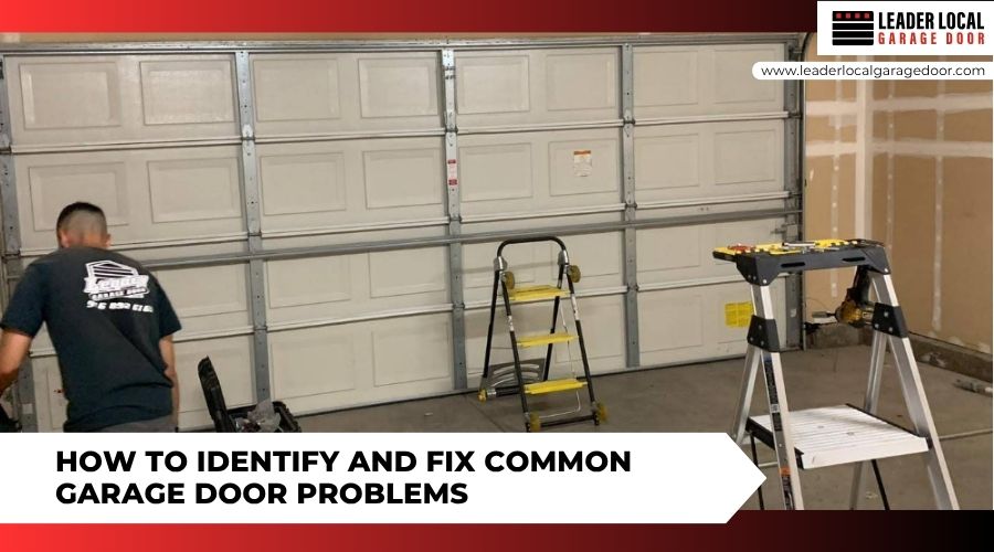 A technician repairing a sectional garage door next to ladders and tools